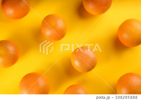 Tasty ripe grapefruits on yellow background, flat lay Tasty ripe grapefruits on yellow background, flat lay 108205888