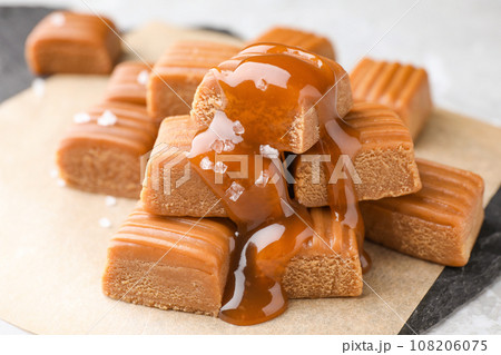 Delicious salted caramel on parchment, closeup view 108206075