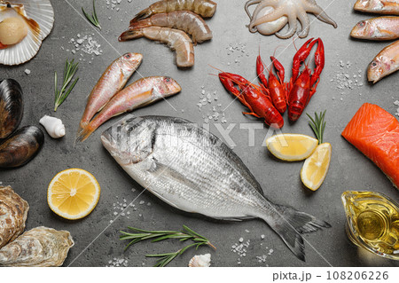 Fresh fish and seafood on grey table, flat lay Fresh fish and seafood on grey table, flat lay 108206226