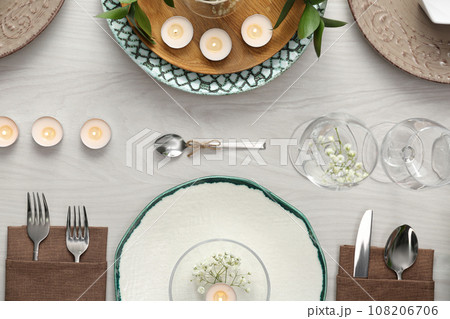Elegant table setting with green plants on white wooden background, flat lay 108206706