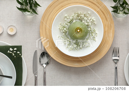 Elegant table setting with green plants on light cloth, flat lay Elegant table setting with green plants on light cloth, flat lay 108206708