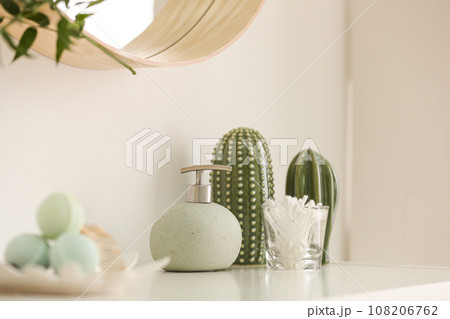 Dispenser and cotton swabs on white shelf in bathroom Dispenser and cotton swabs on white shelf in bathroom 108206762