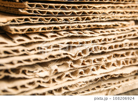 Sheets of brown corrugated cardboard as background, closeup Sheets of brown corrugated cardboard as background, closeup 108206924