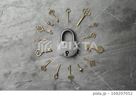 Steel padlock and keys on grey background, top view. Safety concept Steel padlock and keys on grey background, top view. Safety concept 108207052