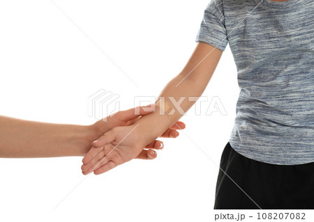 Mother holding son with sticking plaster by hand on white background, closeup Mother holding son with sticking plaster by hand on white background, closeup 108207082
