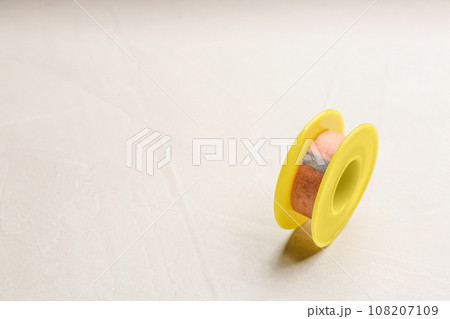 Sticking plaster roll on light stone background. Space for text 108207109
