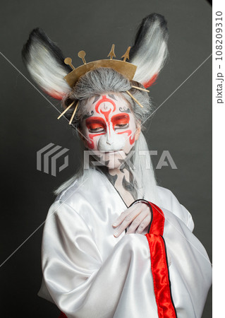 Attractive young woman in Halloween or carnival costume on black background 108209310