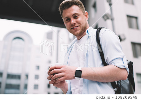 Contemporary man with coffee on street Contemporary man with coffee on street 108209549