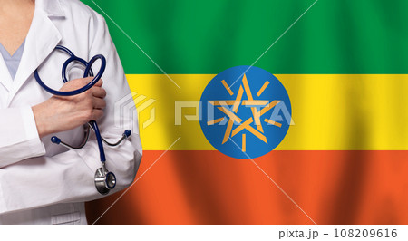 Ethiopian medicine and healthcare concept. Doctor close up against flag of Ethiopia background 108209616