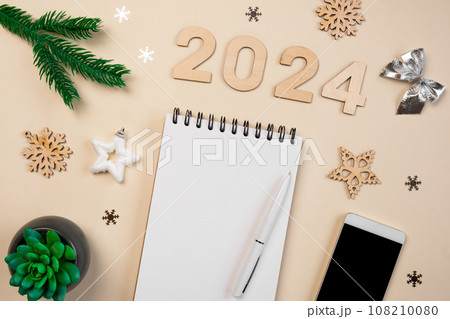 New Year Aims 2024. To Do List. Empty Notebook at the Desk with Holiday Decoration. Top view. Creating Plan, Resolution. New Life, Start Up, Beginning Concept. Business ideas. Goals, action, checklist 108210080
