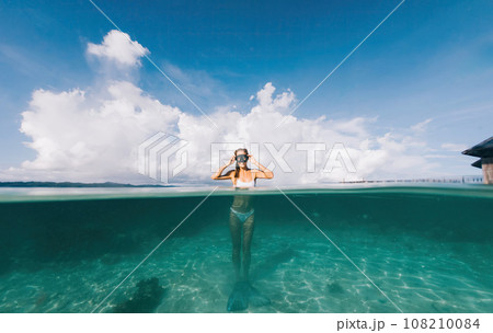 happy woman recreating at tropical island with picturesque seascape for wandering happy woman recreating at tropical island with picturesque seascape for wandering 108210084