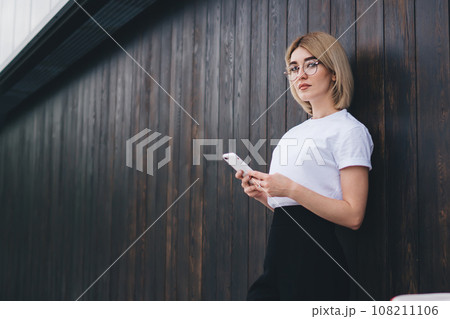 Pretty woman using phone on street Pretty woman using phone on street 108211106