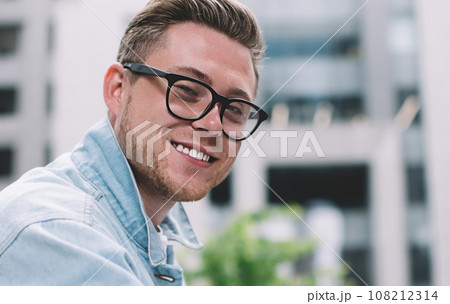Handsome man with smartphone on street 108212314
