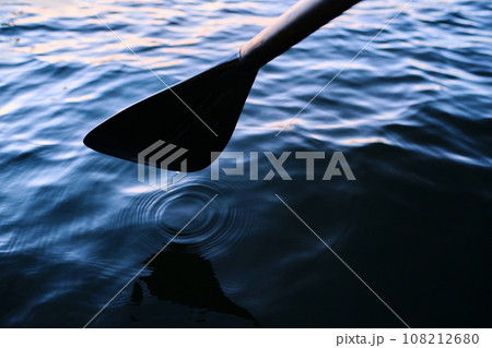 Close-up of an oar against the water. Close-up of an oar against the water. 108212680