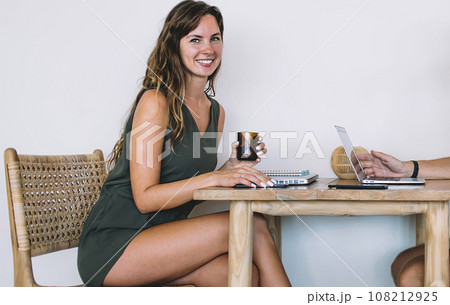 Adult coworkers conversing at cafe 108212925