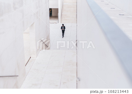 Modern urban underpass and man walking along in distance 108213443
