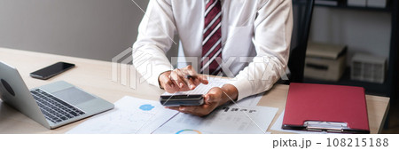 Businessman use calculator to calculate cost of project and checking marketing document of startup 108215188