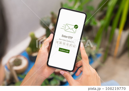 Hand using smartphone and mobile OTP secure verification on send to email with enter password Hand using smartphone and mobile OTP secure verification on send to email with enter password 108219770