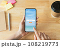 Hand using smartphone and search for vacation travel trips on mobile with booking hotel on website. 108219773