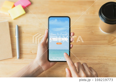 Hand using smartphone and search for vacation travel trips on mobile with booking hotel on website. Hand using smartphone and search for vacation travel trips on mobile with booking hotel on website. 108219773