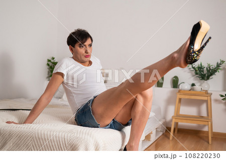 Gay trying on high heels. The guy with makeup. Gay trying on high heels. The guy with makeup. 108220230