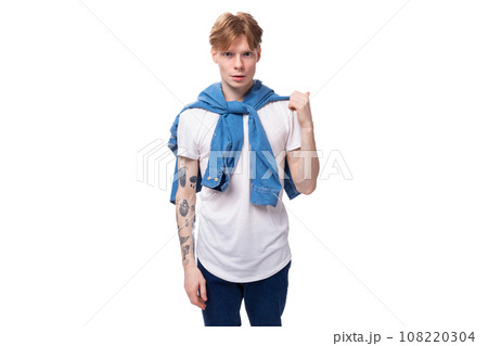 young cute caucasian guy with short red hair with a tattoo on his arms shows his confidence young cute caucasian guy with short red hair with a tattoo on his arms shows his confidence 108220304