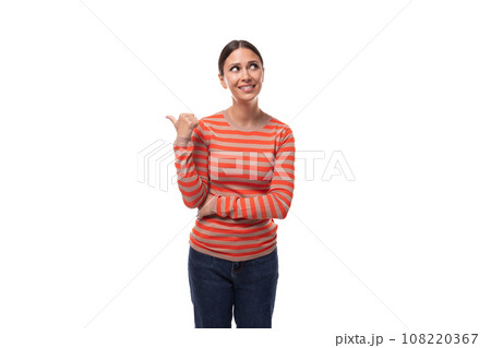 a young caucasian woman with black hair dressed in a striped orange jacket gesticulates with her 108220367