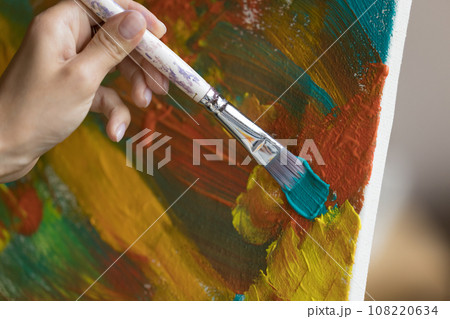 Artist makes brush strokes on canvas painting, close up Artist makes brush strokes on canvas painting, close up 108220634