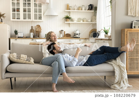 Beautiful loving married couple enjoy rest on couch Beautiful loving married couple enjoy rest on couch 108220679