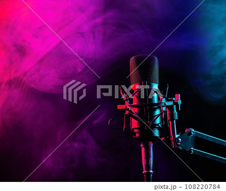 Professional microphone in pink smoke on a black background. 108220784