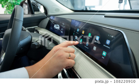 Close-up of a man's hands on the dashboard of a modern car. Close-up of a man's hands on the dashboard of a modern car. 108220910