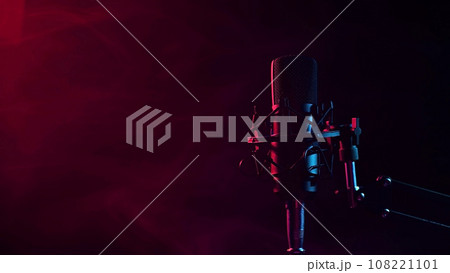 Professional microphone in red smoke on a black background. Professional microphone in red smoke on a black background. 108221101