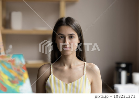 Head shot of attractive young female painter posing in workshop 108221273