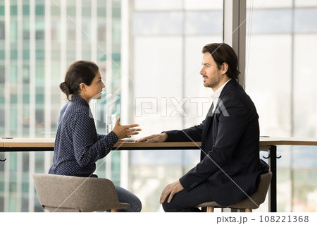 Serious confident diverse colleagues discussing project strategy 108221368