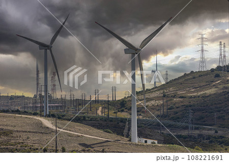 Wind turbines in desert, stormy sky Wind turbines in desert, stormy sky 108221691