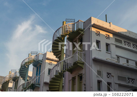Colorful exterior spiral staircases against blue sky, Singapore 108222071