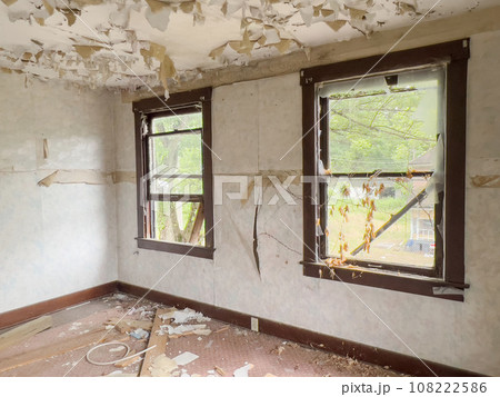 broken windows of an abandoned house with pealed ceiling broken windows of an abandoned house with pealed ceiling 108222586
