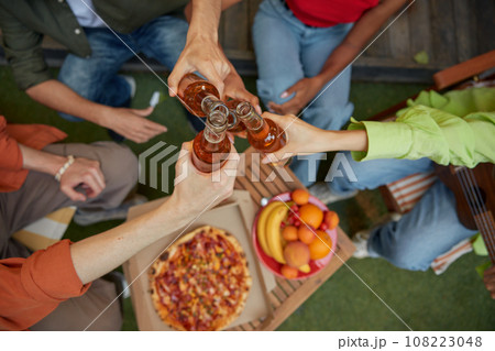 Friends clinking beer bottles view from top 108223048
