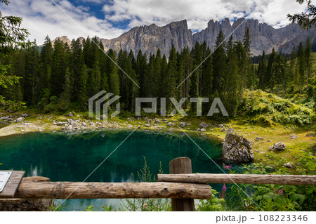 Landscape of Lake Carezza or Karersee and Dolomites in background, Nova Levante, Italy Landscape of Lake Carezza or Karersee and Dolomites in background, Nova Levante, Italy 108223346