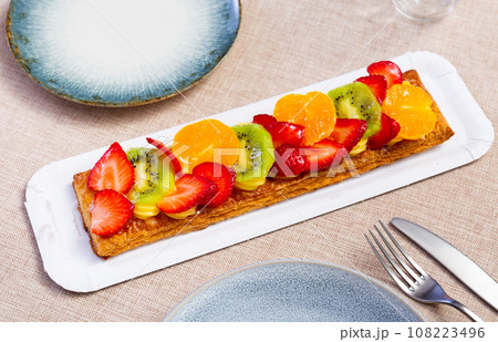 Puff pastry tart with custard, fruits and berries Puff pastry tart with custard, fruits and berries 108223496