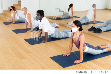 Young woman practicing yoga at group class 108223912