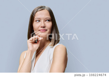 Beauty portrait of young woman with natural trendy makeup on grey background Beauty portrait of young woman with natural trendy makeup on grey background 108224674