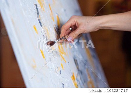 The artist paints an abstract painting using mastichin. The artist paints an abstract painting using mastichin. 108224717