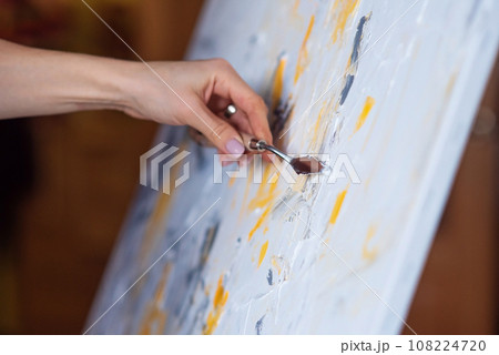 The abstract painting created with mastic and yellow paint. The abstract painting created with mastic and yellow paint. 108224720