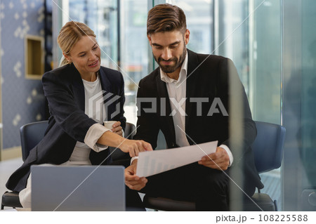 Business partners have meeting in cafe to solve biz issues and work with documets Business partners have meeting in cafe to solve biz issues and work with documets 108225588