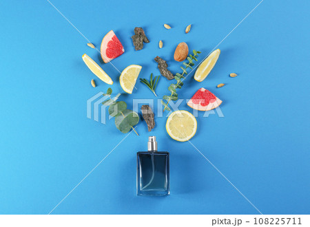 Flat lay composition with bottle of perfume on blue background 108225711