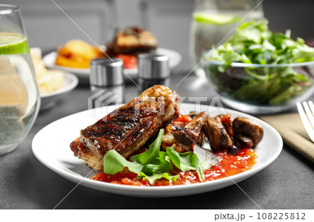 Delicious grilled ribs served on grey table 108225812