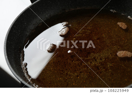 Used cooking oil in frying pan, closeup 108225949