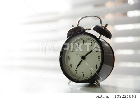 Alarm clock on windowsill, space for text. Morning time Alarm clock on windowsill, space for text. Morning time 108225961