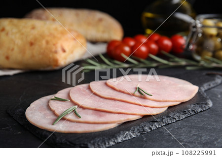 Slices of tasty ham on black table, closeup Slices of tasty ham on black table, closeup 108225991